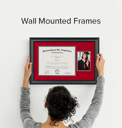 Woman hanging a diploma, in a red and black frame; on her wall.