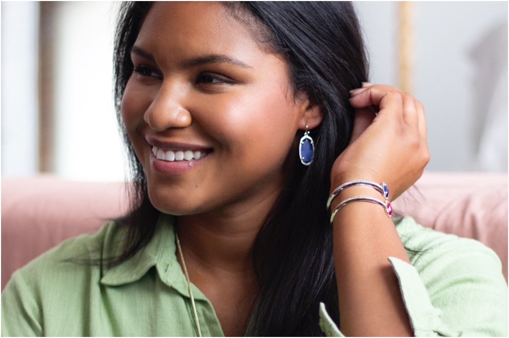 A woman wearing Color Collection earrings and bracelets